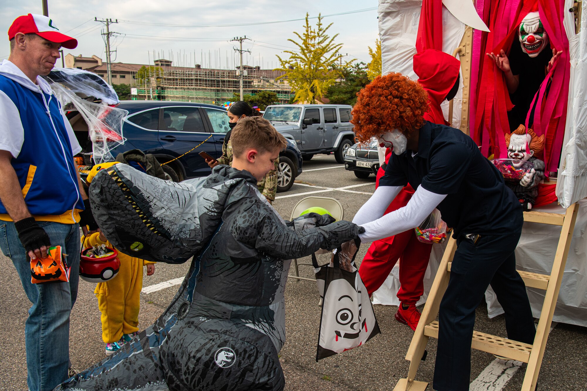 Volunteers pass out candy to attendees of the Fall Festival & Trunk or Treat event hosted by the 51st Force Support Squadron Oct. 30, 2021, at Osan Air Base, Republic of Korea.