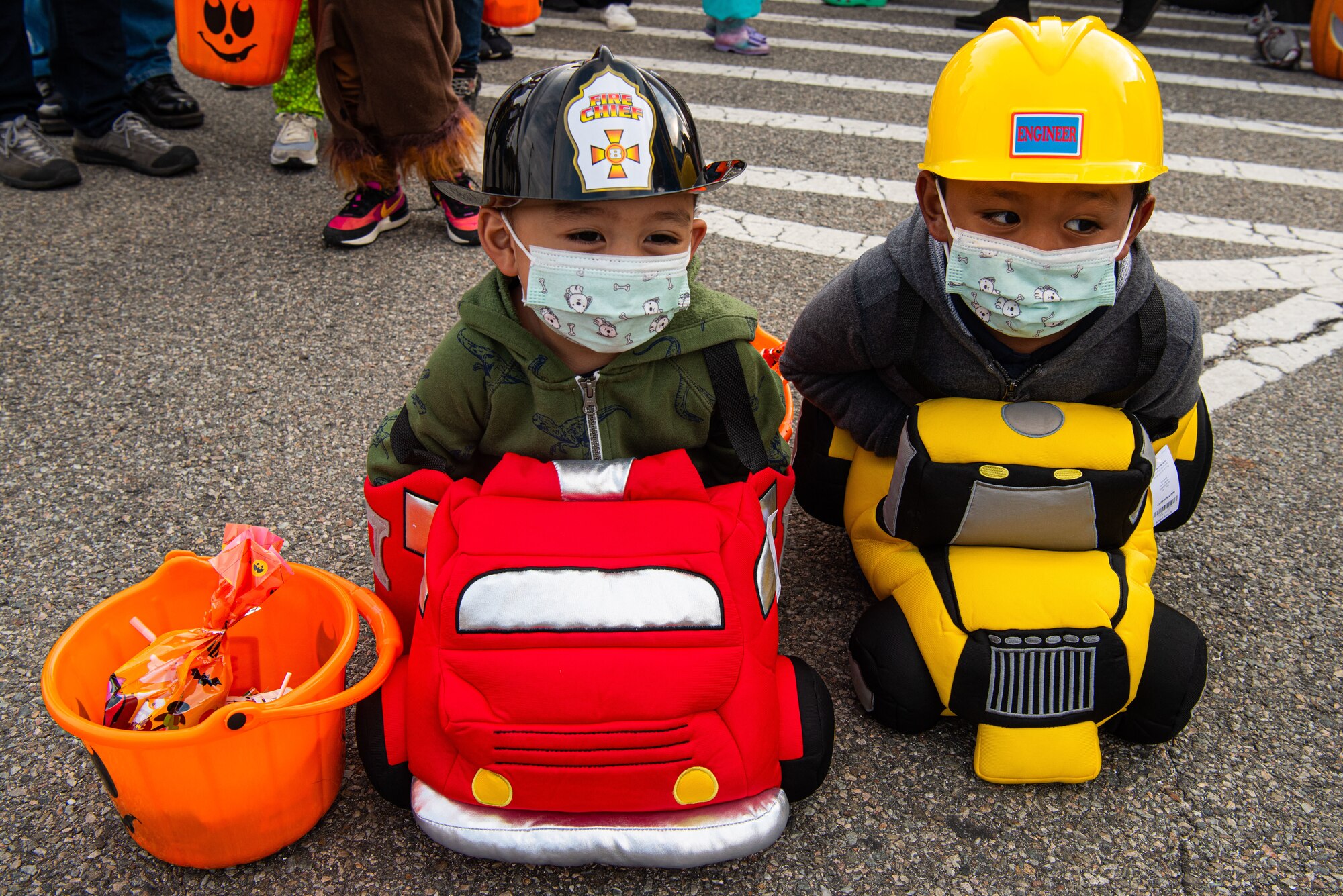 Children attending the Fall Festival & Trunk or Treat event hosted by the 51st Force Support Squadron smile at those passing by Oct. 30, 2021, at Osan Air Base, Republic of Korea.