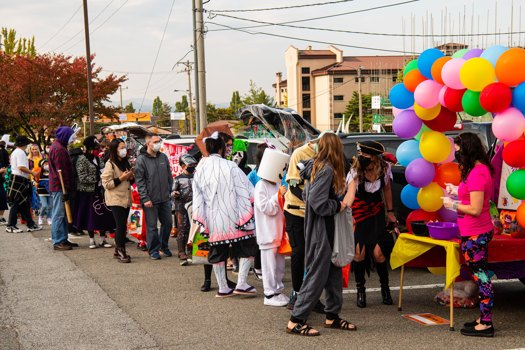 Families line up and wait to enter the Fall Festival & Trunk or Treat event hosted by the 51st Force Support Squadron Oct. 30, 2021, at Osan Air Base, Republic of Korea.