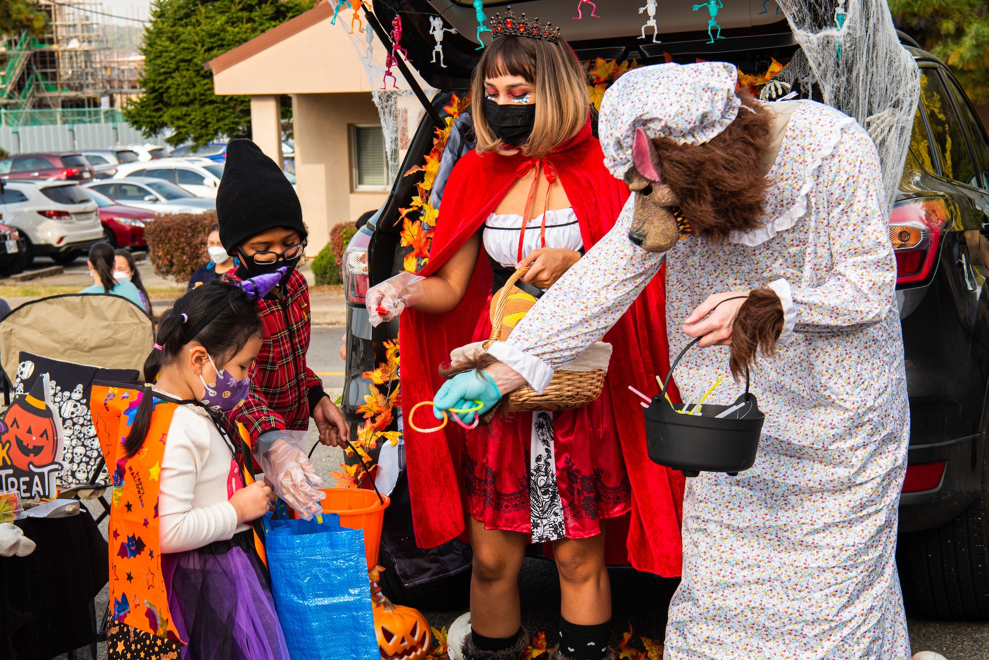 Volunteers pass out candy to attendees of the Fall Festival & Trunk or Treat event hosted by the 51st Force Support Squadron Oct. 30, 2021, at Osan Air Base, Republic of Korea.