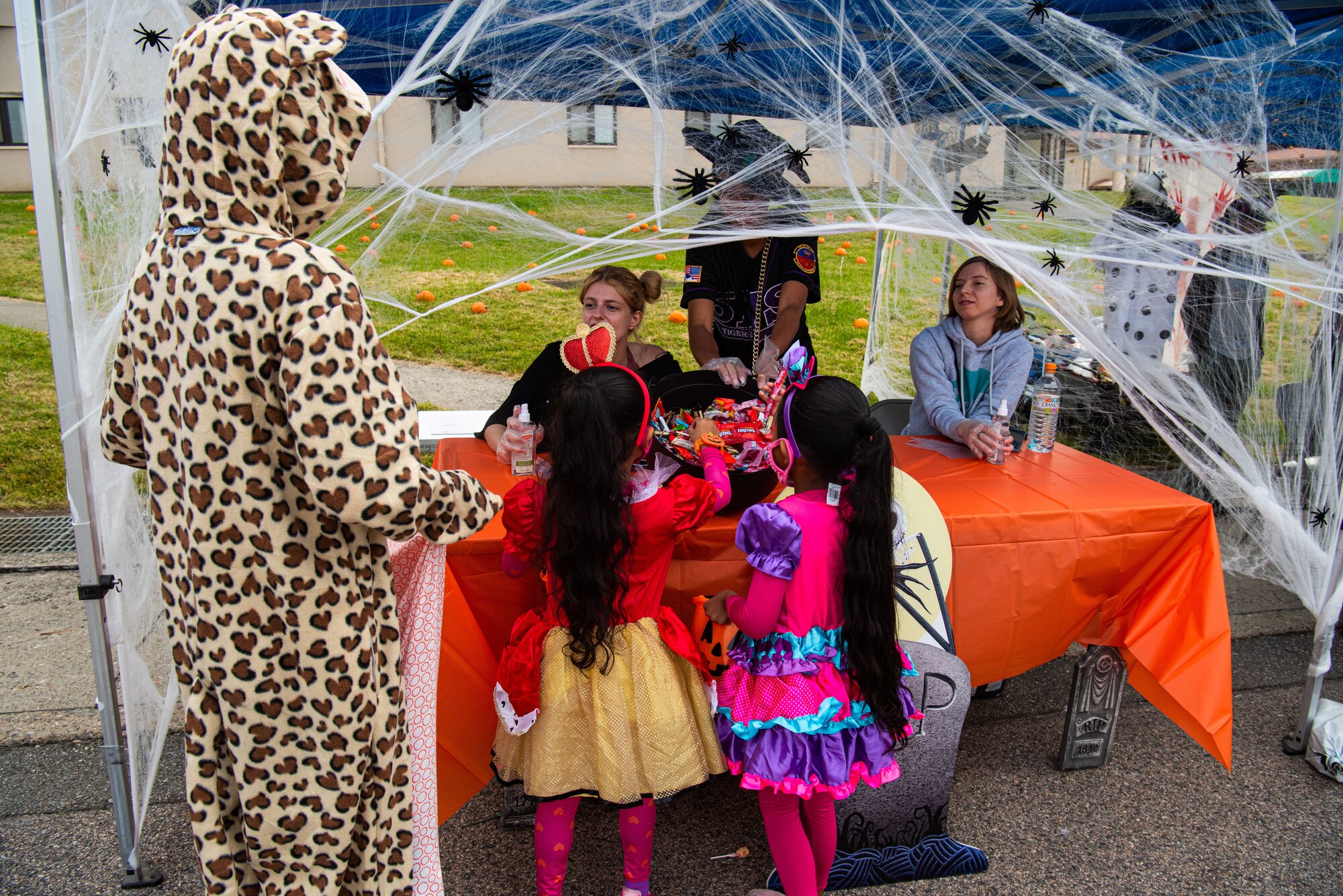 Volunteers pass out candy to attendees of the Fall Festival & Trunk or Treat event hosted by the 51st Force Support Squadron Oct. 30, 2021, at Osan Air Base, Republic of Korea.