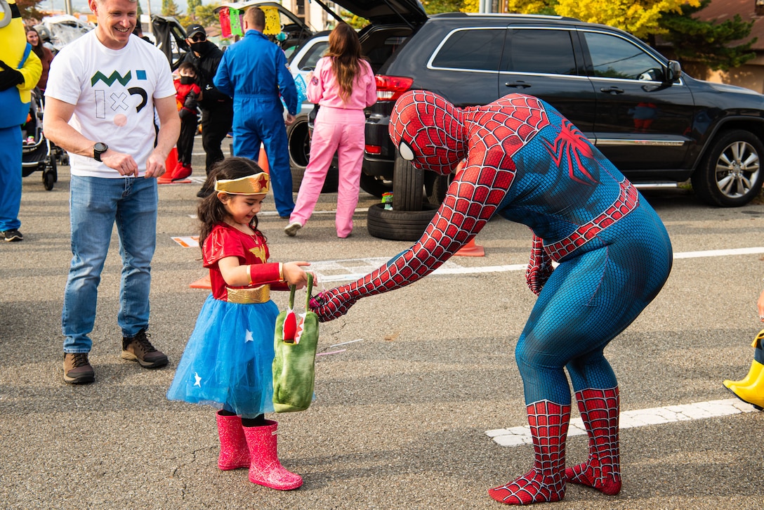 Volunteers pass out candy to attendees of the Fall Festival & Trunk or Treat event hosted by the 51st Force Support Squadron Oct. 30, 2021, at Osan Air Base, Republic of Korea.