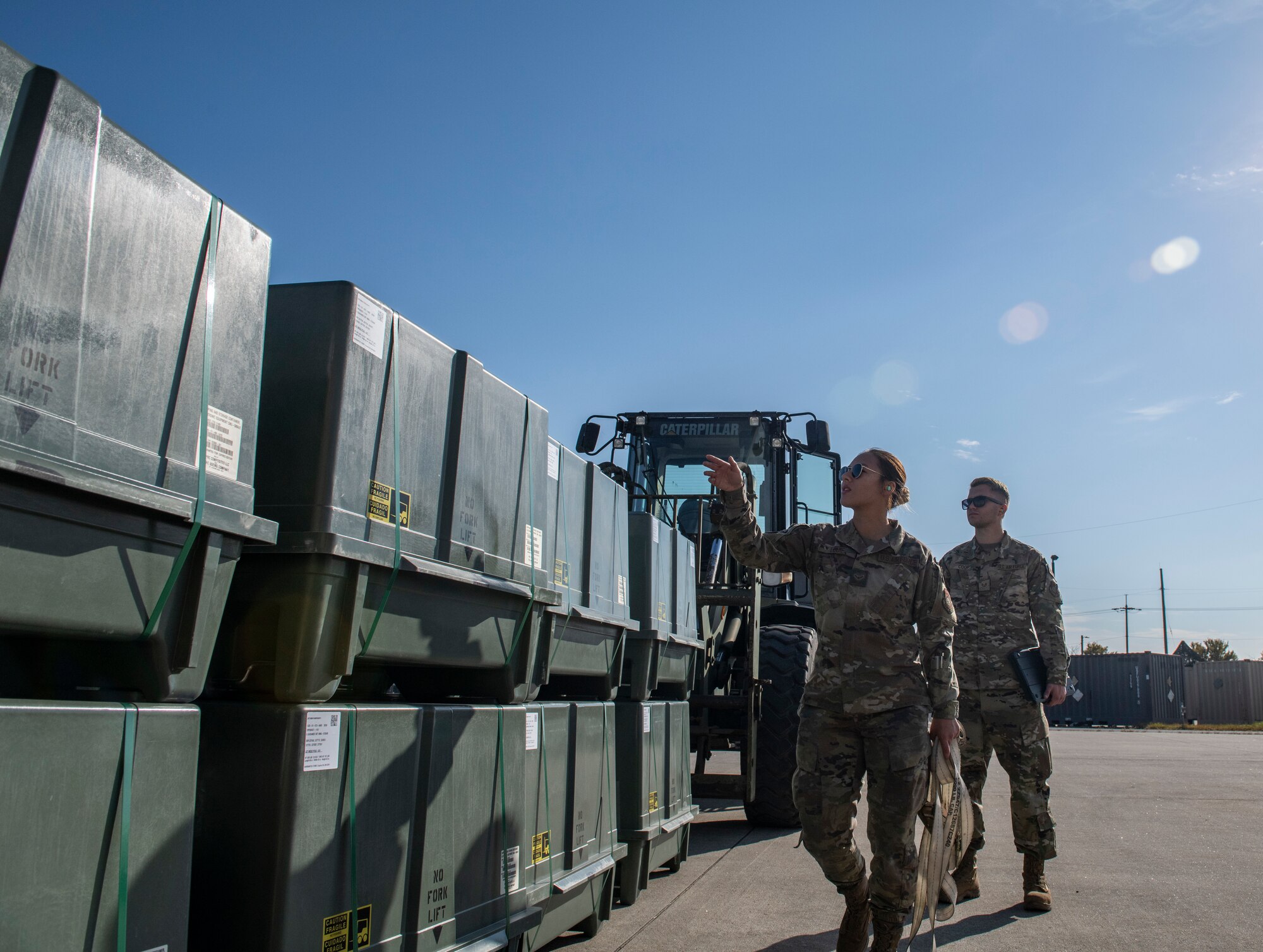 Stockpile management technicians, from the 8th Maintenance Squadron, inspect storage containers at Kunsan Air Base, Republic of Korea, Oct. 29, 2021. Munitions Airmen work with extreme care to handle, store, transport, arm and disarm weapons systems. (U.S. Air Force photo by Staff Sgt. Suzie Plotnikov)