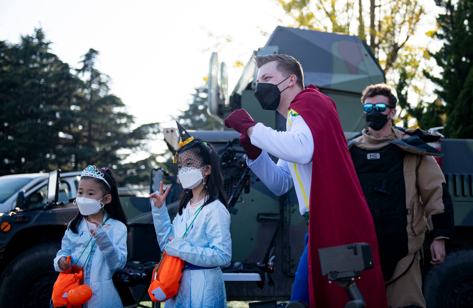 Airmen from the 8th Civil Engineer Squadron Explosive Ordnance Disposal hands out many and poses for a group photo during Kunsan’s Annual Halloween Trick-or-Treat at Kunsan Air Base, Republic of Korea, October, 28, 2021. The 8th Civil Engineer Squadron hosted this years event which was open to all U.S. Military and South Korean Nationals with base access. (U.S. Air Force photo by Senior Airman Suzie Plotnikov)