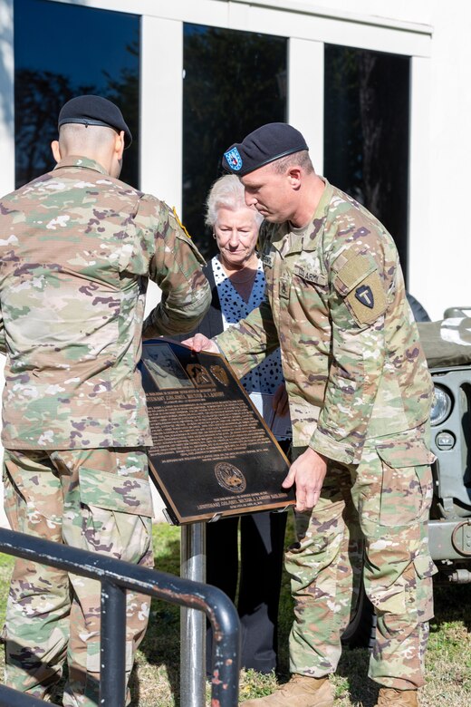 People placing a plaque.