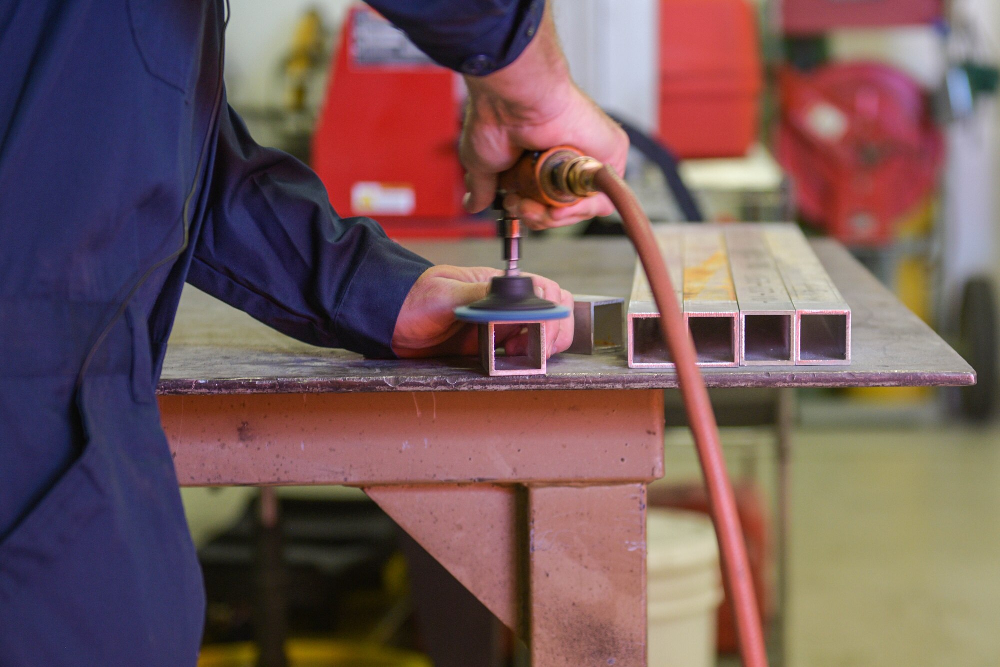 Chief Master Sgt. Jeremy L. Unterseher, 31st Fighter Wing command chief, prepares a metal leg before welding it at Aviano Air Base, Italy, Aug. 30, 2021. Chief Unterseher entered the Air Force in August of 1995 and graduated from the Navy School Explosive Ordnance Disposal (EOD) in June 1996. His background includes various duties in the EOD career field at unit and higher levels. (U.S. Air Force photo by Senior Airman Brooke Moeder)