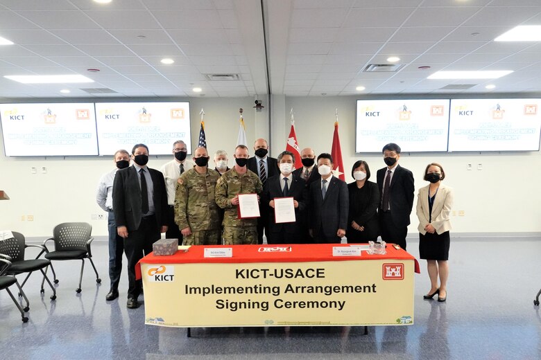 Brig. Gen. Kirk Gibbs, U.S. Army Corps of Engineers Pacific Ocean Division commander; Dr. Kim Byung-suk, Korea Institute of Civil Engineering and Building Technology president, hold the signed Implementing Arrangement, while posing for a photo with senior leaders from the KICT and the Far East District, Aug. 27.