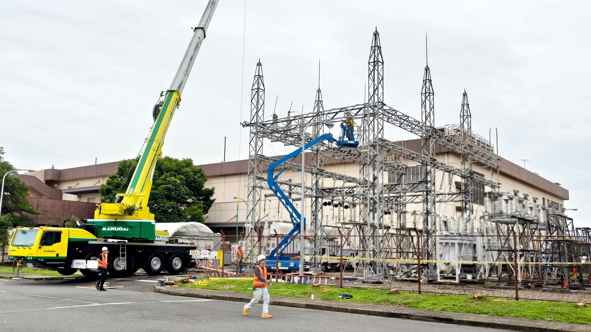 contractors work on a natural gas-powered steam plant’s electrical switchyard