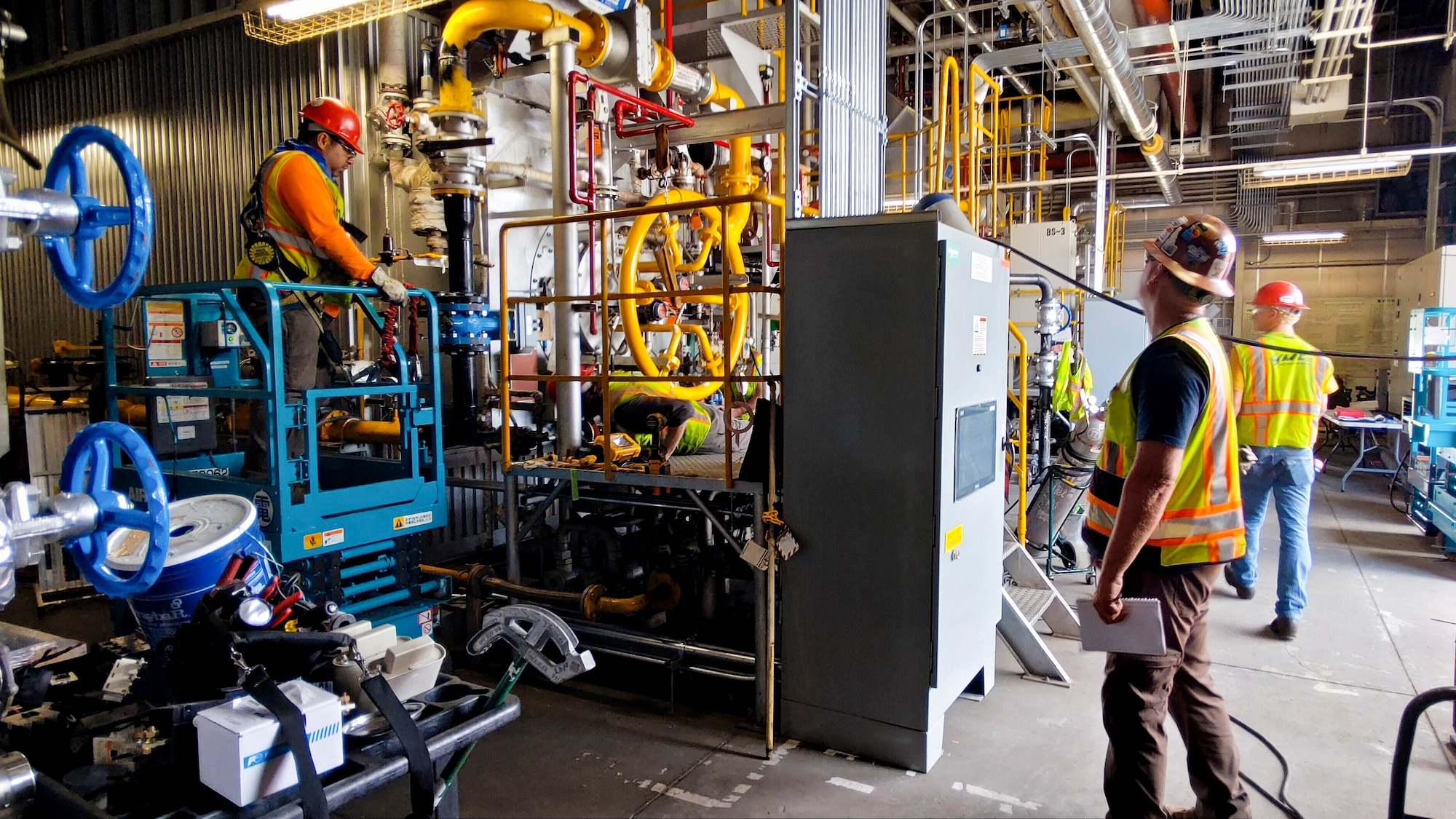 Contractors work on a natural gas-powered steam plant