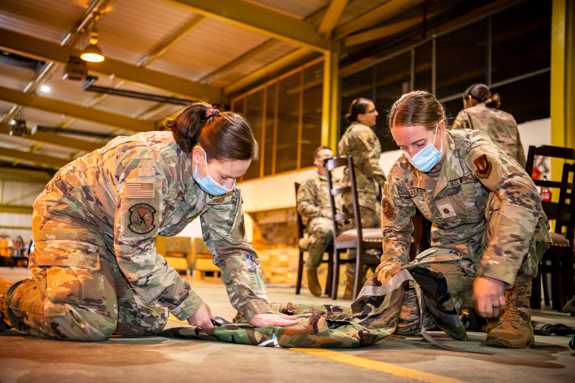 U.S. Air Force Master Sgt. Terri Adams, left, 423d Civil Engineer Squadron NCO in charge of emergency management and Maj. Erica Balfour, 423d Communications Squadron commander, prepare Mission Oriented Protective Posture gear prior to participating in Ability to Survive and Operate training at RAF Alconbury, England, Aug. 27, 2021. The ATSO rodeo was designed to reinforce Airmen’s ability to properly utilize their MOPP gear in a potential chemical environment. (U.S. Air Force photo by Senior Airman Eugene Oliver)