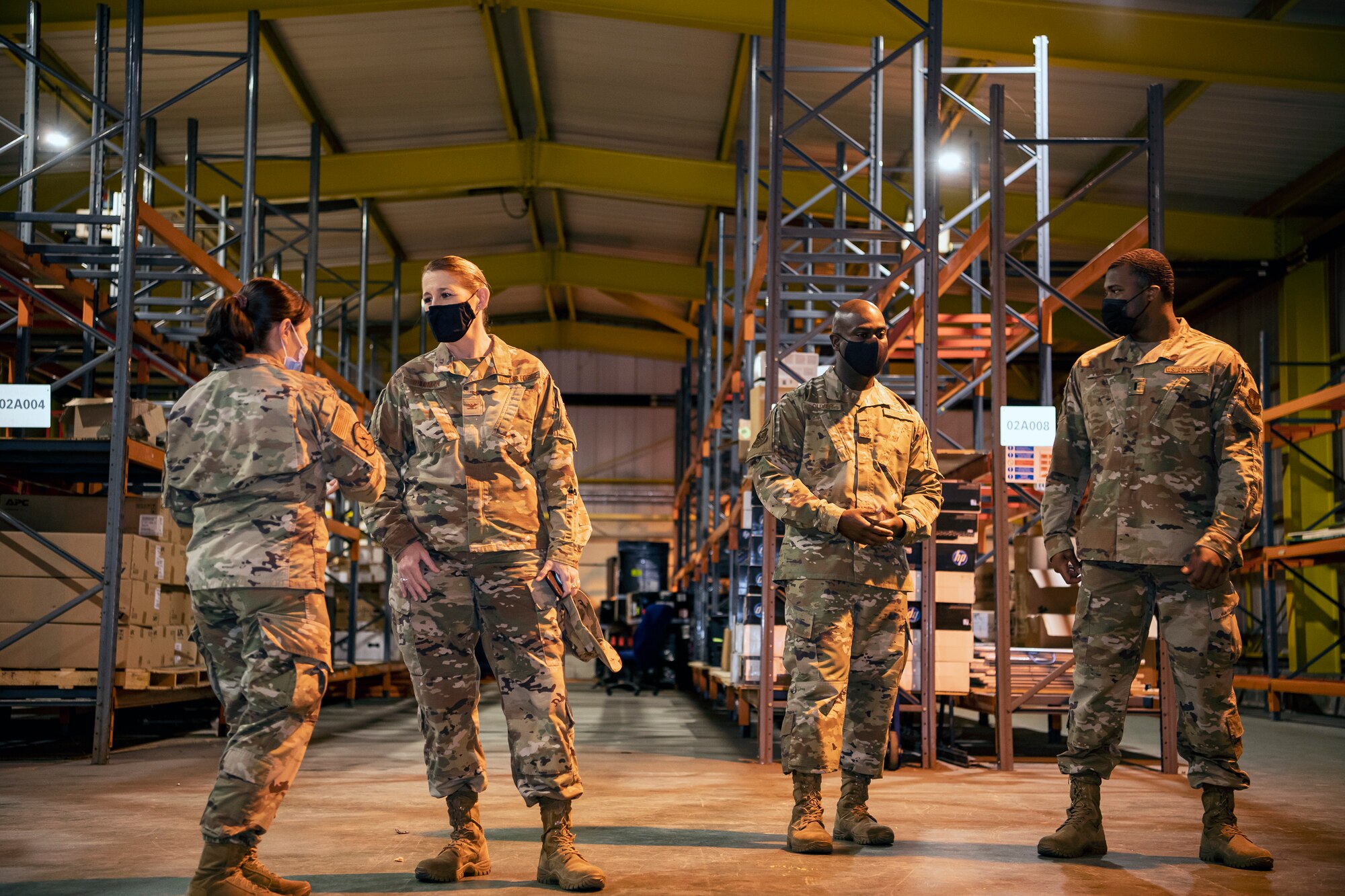 Col. Lisa Wildman, center left, 501st Combat Support Wing vice commander, and Chief Master Sgt. Ralph Oliver, center right, 423d Air Base Group group senior enlisted leader speak with Airmen during Ability to Survive and Operate training at RAF Alconbury, England, Aug. 27, 2021. The ATSO rodeo was designed to reinforce Airmen’s ability to properly utilize their MOPP gear in a potential chemical environment. (U.S. Air Force photo by Senior Airman Eugene Oliver)