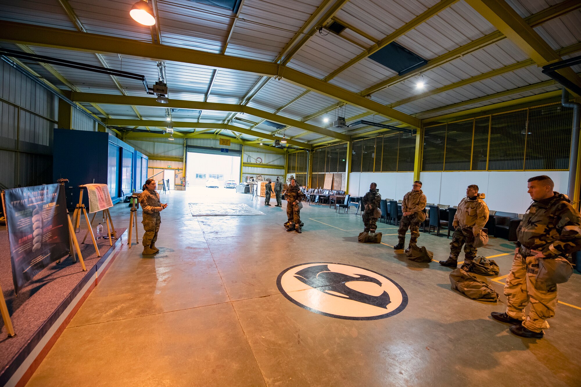 U.S. Air Force Master Sgt. Terri Adams, left, 423d Civil Engineering squadron NCO in charge of emergency management, briefs Airmen from the 501st Combat Support Wing during Ability to Survive and Operate training at RAF Alconbury, England, Aug. 27, 2021. The ATSO rodeo was designed to reinforce Airmen’s ability to properly utilize their MOPP gear in a potential chemical environment. (U.S. Air Force photo by Senior Airman Eugene Oliver)