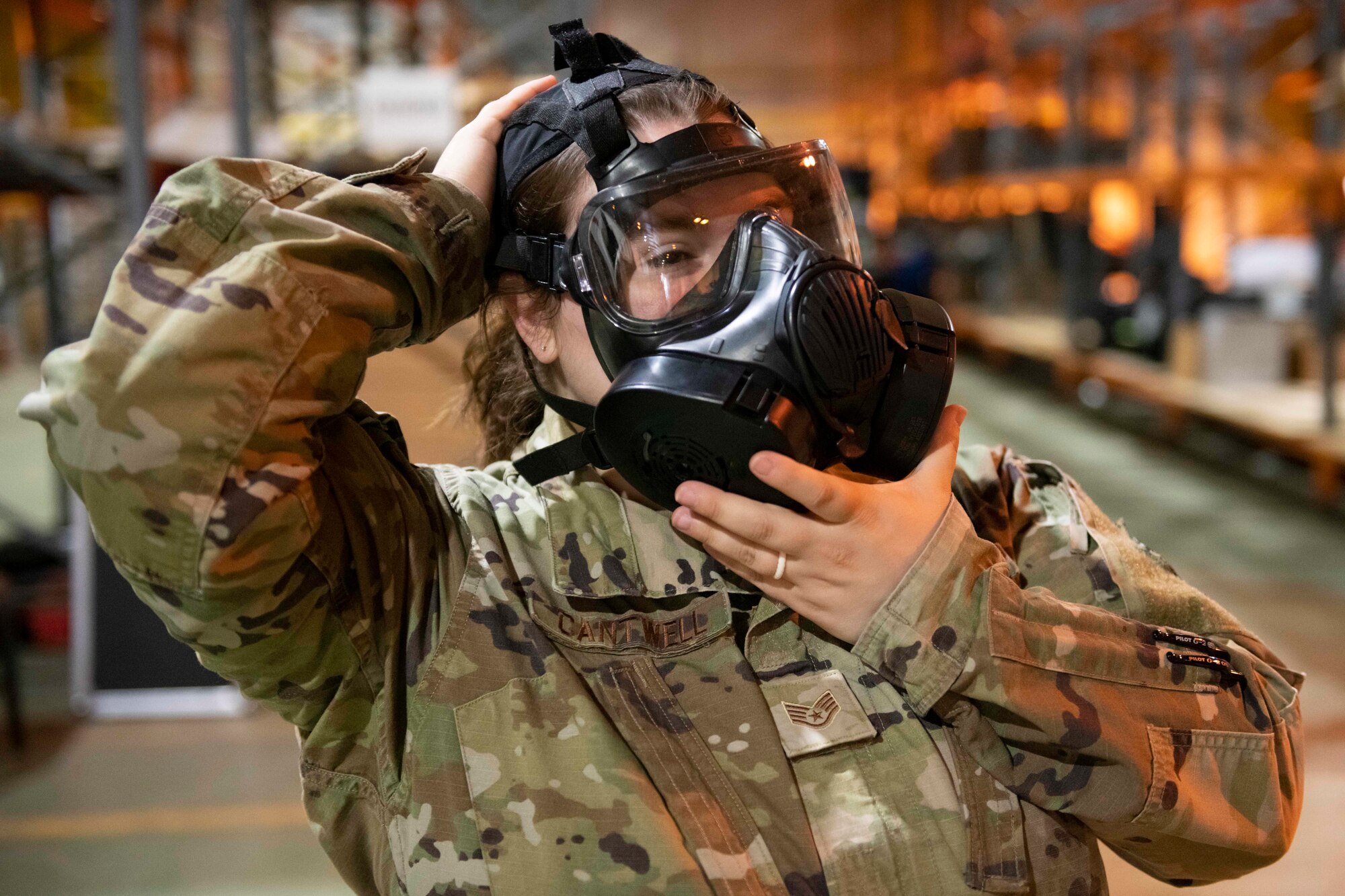 Airmen from the 501st Combat Support Wing don their Mission Oriented Protective Posture gear during Ability to Survive and Operate training at RAF Alconbury, England, Aug. 26, 2021. Airmen participated in the ATSO rodeo to get a refresher on how to properly utilize their MOPP gear in a potential chemical environment. (U.S. Air Force photo by Senior Airman Jennifer Zima)
