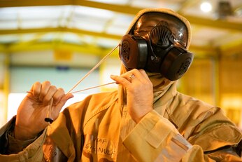 Airmen from the 501st Combat Support Wing don their Mission Oriented Protective Posture gear during Ability to Survive and Operate training at RAF Alconbury, England, Aug. 26, 2021. Airmen participated in the ATSO rodeo to get a refresher on how to properly utilize their MOPP gear in a potential chemical environment. (U.S. Air Force photo by Senior Airman Jennifer Zima)