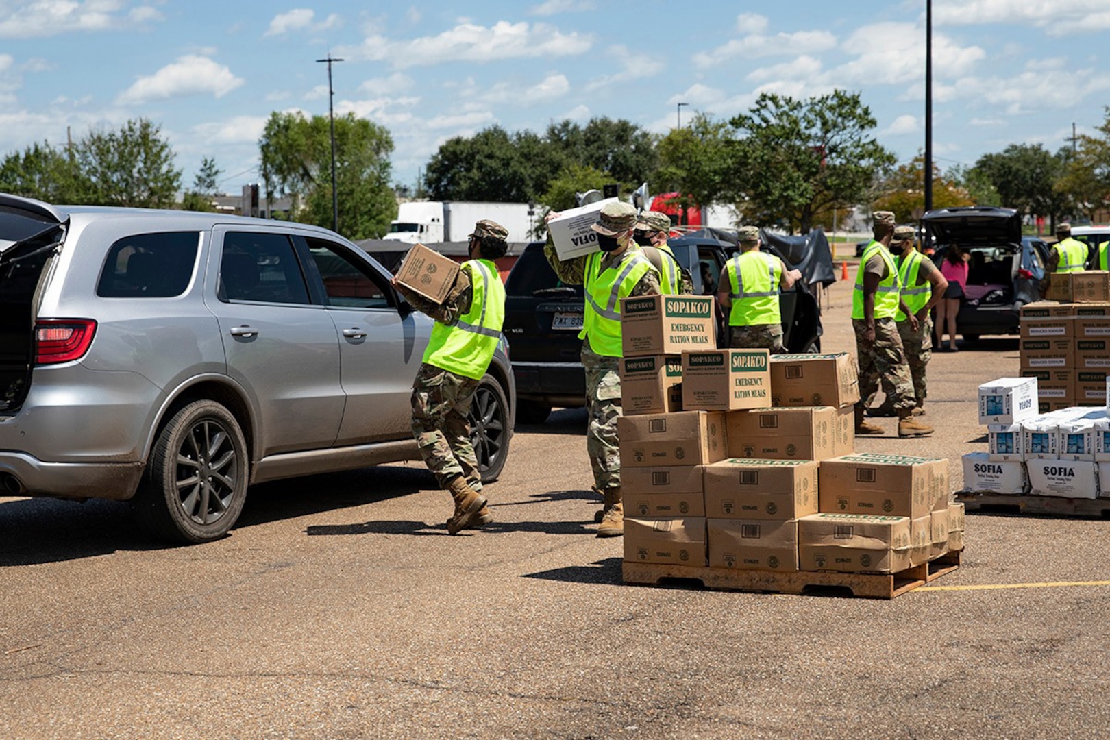Members of the Louisiana National Guard distribute meals ready to eat at one of nine distribution points set up across three parishes to aid in the recovery from Hurricane Ida.
