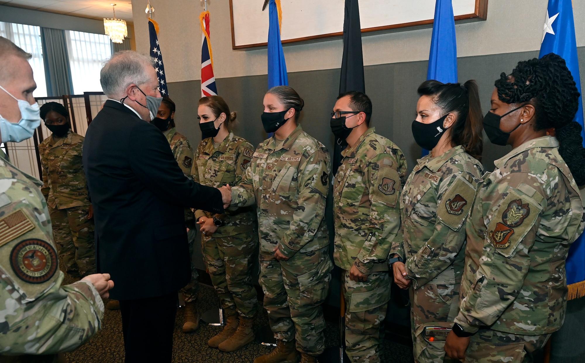 Secretary of the Air Force Frank Kendall hands out coins to Airmen after having a meeting with them at Joint Base Pearl Harbor-Hickam, Hawaii, Aug. 17, 2021. Kendall visited the base to meet Airmen and Guardians and emphasized his top priorities. (U.S. Air Force photo by Wayne Clark)