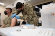 Army Cpl. Jonathan Leon Camacho, a practical nursing specialist with Dwight D. Eisenhower Army Medical Center at Fort Gordon, Ga, injects an Army Reserve Soldier from the 447th Military Police Company with the COVID-19 vaccination, Aug 21, 2021, at Camp Shelby Joint Forces Training Center (CSJFTC), Miss. The mobilized soldiers based out of North Canton, Ohio, are at CSJFTC training for an upcoming deployment.(Arizona Army National Guard photo by Sgt. 1st Class Brian A. Barbour)
