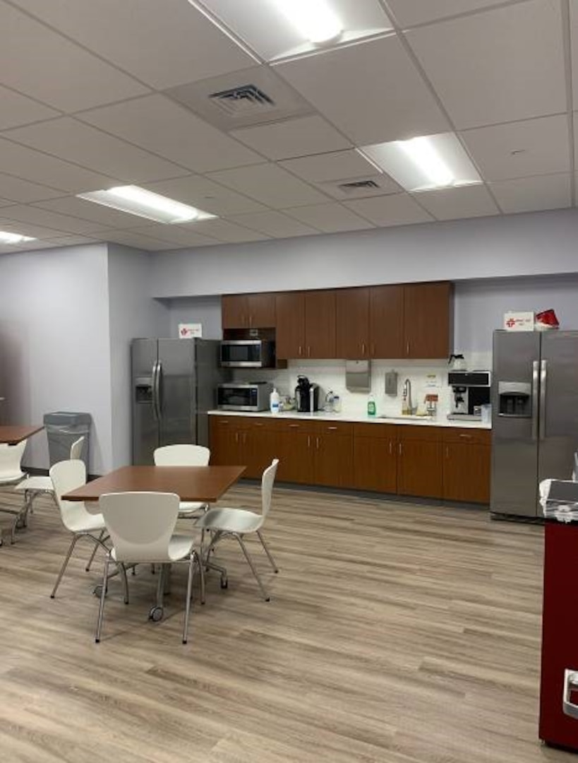 office break room with tables, chairs, refridgerators, and microwave for employees use.