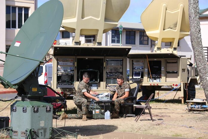 Lance Cpl. William Coward (left), a digital wideband technician, and Lance Cpl. Robert Murphy, a satellite operator, both of 3rd Marine Regiment, test a Very Small Aperture Terminal satellite system during Island Marauder 21 on Aug. 9 at Marine Corps Base Hawaii. Island Marauder is an annual, Marine Corps Systems Command-led exercise enabling Marines to assess and familiarize themselves with communications gear. This year’s exercise was nested under the Navy’s Large Scale Exercise 21.