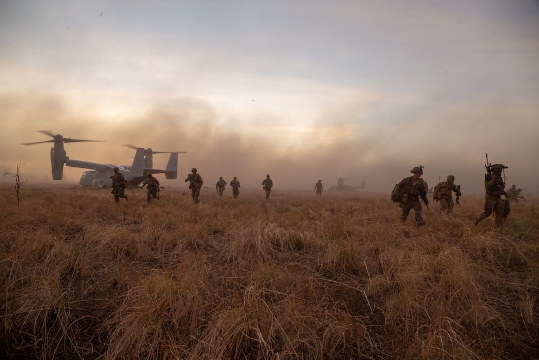 U.S. Marines with Company A., 1st Battalion, 7th Marine Regiment, Marine Rotational Force – Darwin dismount two MV-22B Ospreys during Exercise Koolendong at Bradshaw Field Training Area, NT, Australia, Aug. 29, 2021. U.S. Marines and Australian Army soldiers worked together to conduct a simulated aerial assault during the exercise. Exercise Koolendong validates MRF-D’s and the Australian Defence Force’s ability to conduct expeditionary command and control operations, demonstrating the shared commitment to being ready to respond to a crisis or contingency in the Indo-Pacific region.