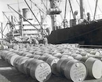 oil barrels line a pier