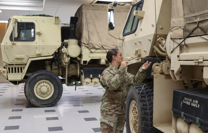 Spc. Stephanie Sparrow, a wheeled vehicle repairer with 3622nd Support Maintenance Company, 728th Combat Sustainment Support Battalion, 213th Regional Support Group, Pennsylvania Army National Guard, checks the oil on one of the eight high-clearance vehicles her unit has readied to respond to Tropical Storm Ida Sept. 1 at Fort Indiantown Gap. About 120 Pennsylvania National Guard members total with approximately 35 vehicles have been placed on state active duty and are on stand-by as Ida bears down on Pennsylvania. (U.S. Army National Guard photo by Staff Sgt. Zane Craig)