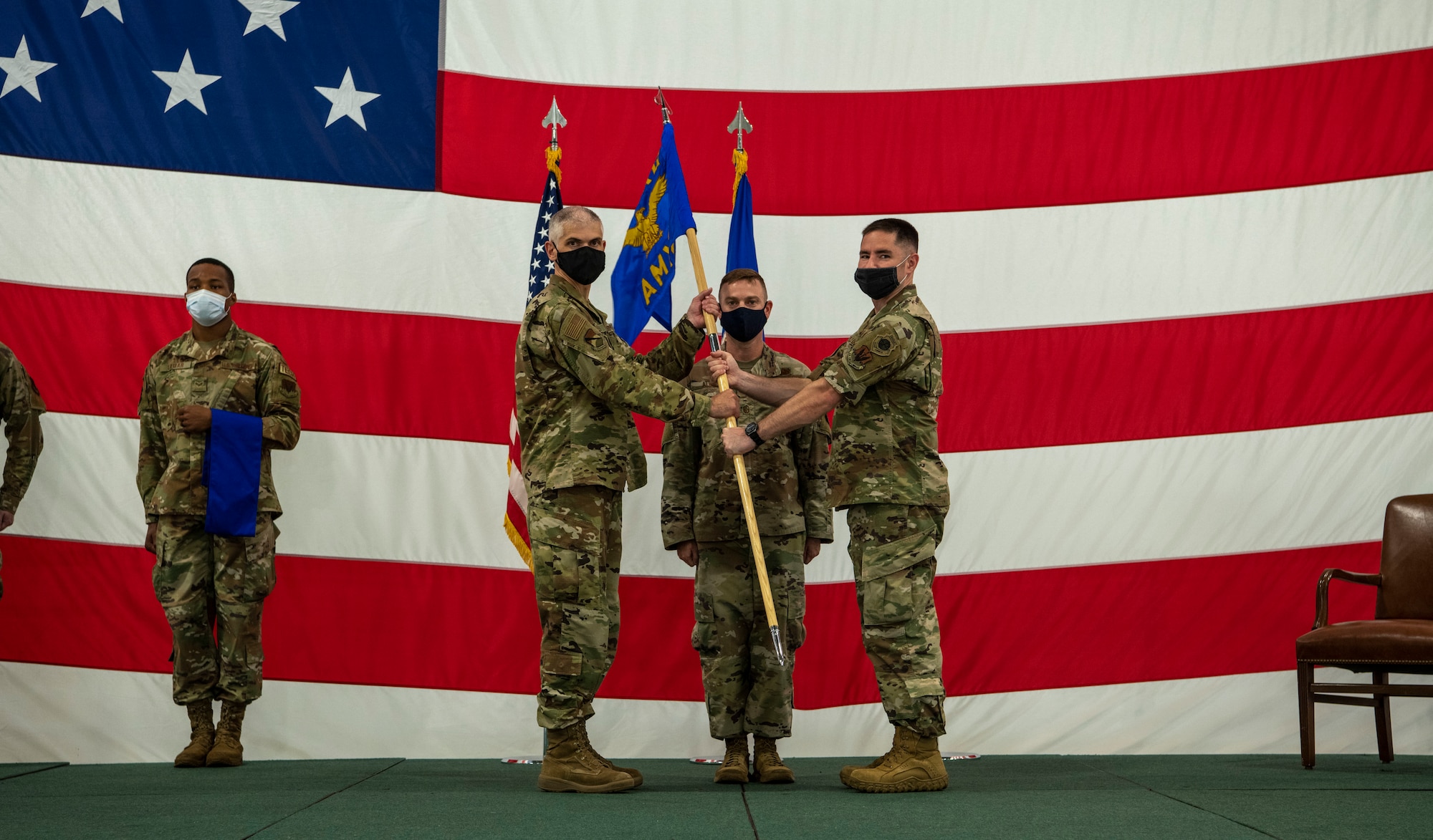 two men hold a guidon