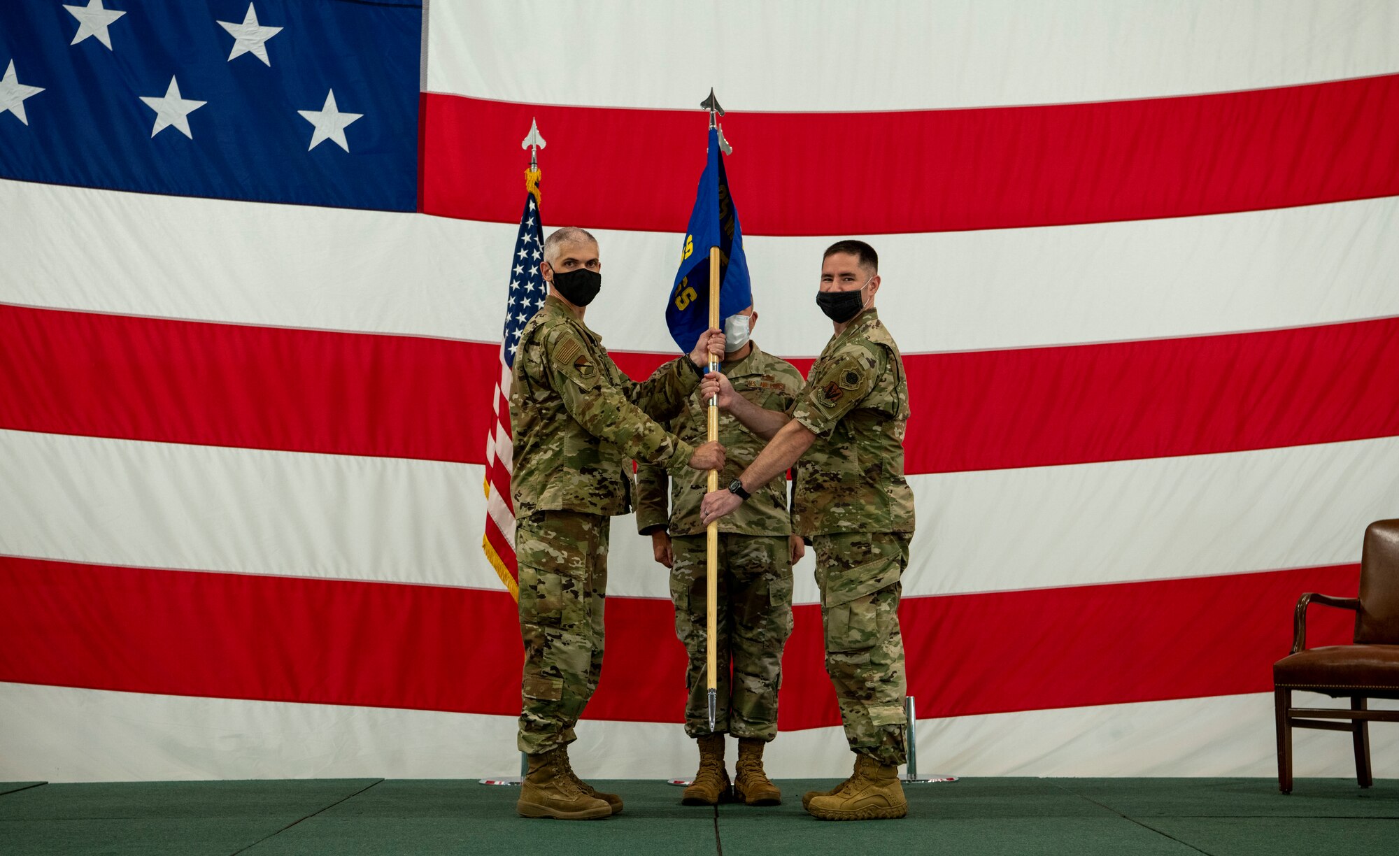 two men hold a guidon