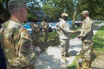 From right, U.S. Air Force Maj. Gen. Joel Jackson, Air Force District of Washington commander; Chief Master Sgt. Leon Calloway, AFDW command chief; Lt. Col. Robert Kline, AFDW executive officer; and Col. Paul Filcek, AFDW deputy commander, listen to Senior Airman Jose DeJesus-Bermudez, 11th Security Forces Squadron, inside the gate guard shack at Joint Base Anacostia-Bolling, Washington, D.C., Aug. 25, 2021. The AFDW command team visited various sections of the wing and select base mission partners during a two-day immersion tour to listen, learn, take questions, and recognize the achievements of unit Airmen and mission partners. (U.S. Air Force photo by Benjamin Matwey)