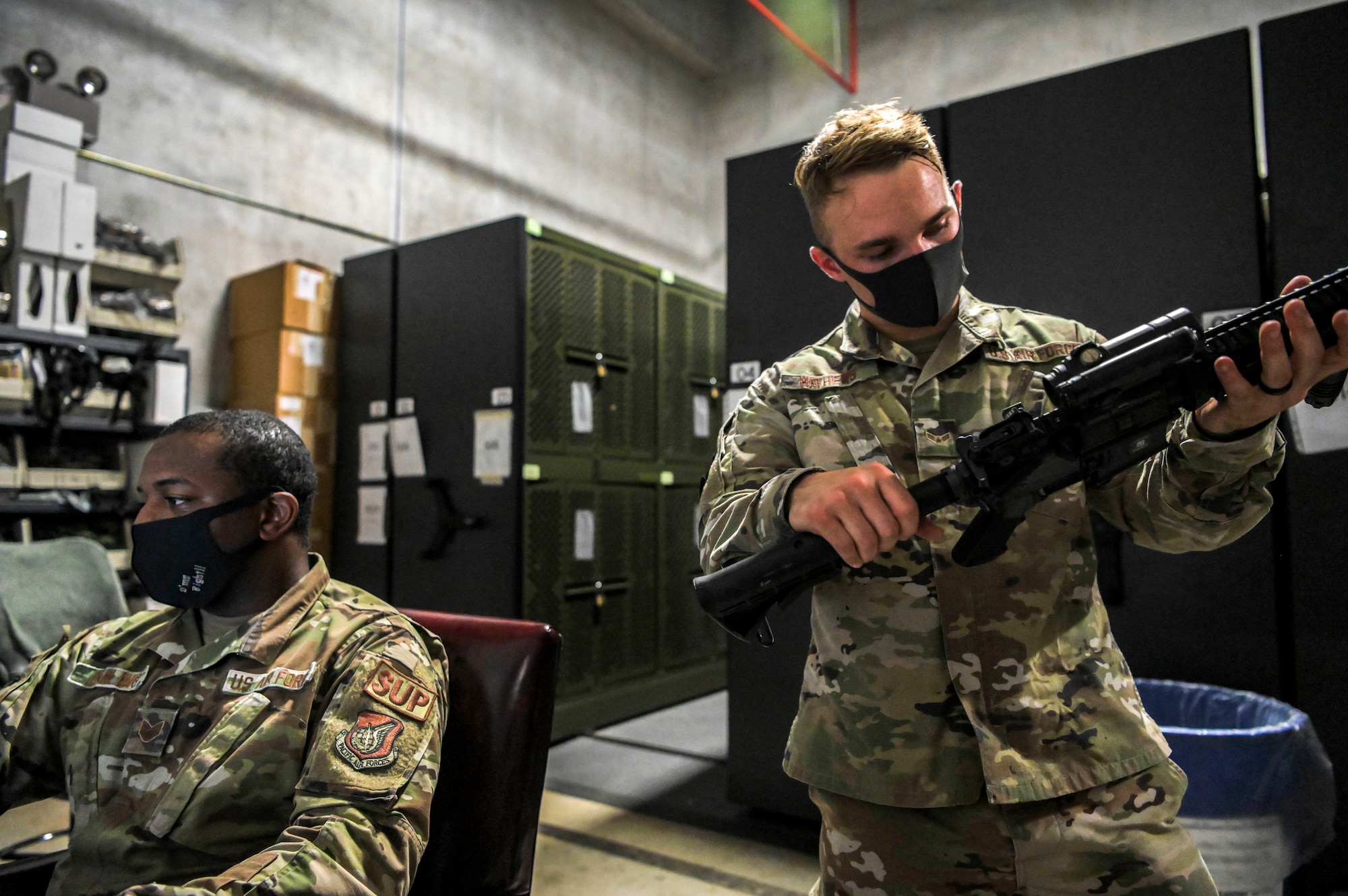 Airmen record the serial number of an issued weapon
