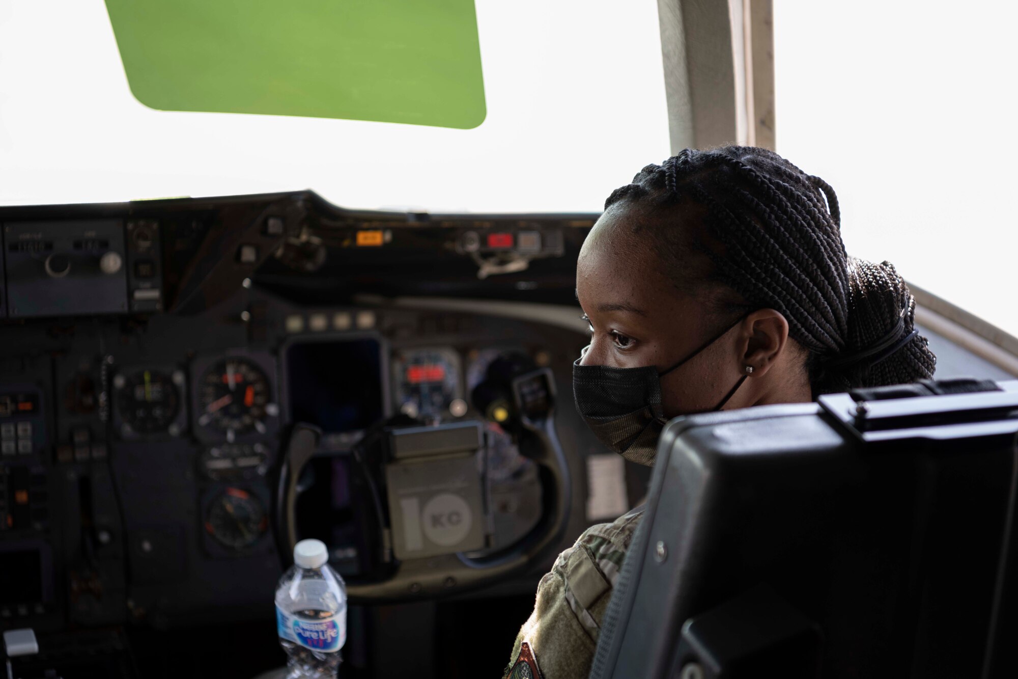 Airman sits in the co-pilots seat in an aircraft