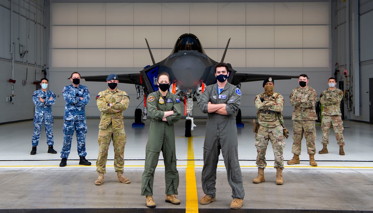 Pilots, security forces, aircraft maintainers and logistics personnel from the Royal Australian Air Force (left) and the U.S. Air Force (right) pose in front of an F-35A Lightning II assigned to the 355th Fighter Squadron during RED FLAG-Alaska 21-3 on Eielson Air Force Base, Alaska, Aug. 27, 2021. This iteration of the exercise focused on the interoperability of allied fifth-generation assets, such as the F-35A Lightning II, as well as cyber and intelligence warfare capabilities. (U.S. Air Force photo by Senior Airman Beaux Hebert)