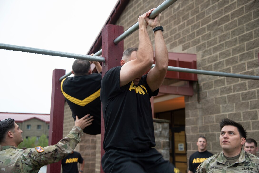 Soldiers with the U.S. Army Corps of Engineers – Alaska District perform leg tucks during the Army Combat Fitness Test on Aug. 17 at Joint Base Elmendorf Richardson.