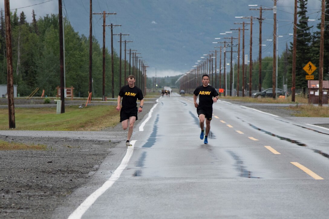 Col. Damon Delarosa (right), commander of the U.S. Army Corps of Engineers – Alaska District, and Capt. Justin Dermond (left), project engineer, race to the finish line of the two-mile run during the Army Combat Fitness Test on Aug. 17 at Joint Base Elmendorf Richardson.