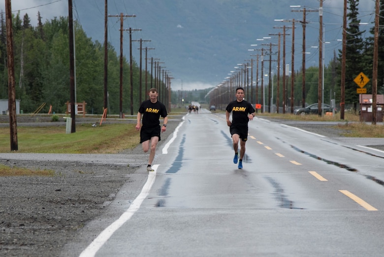 Col. Damon Delarosa (right), commander of the U.S. Army Corps of Engineers – Alaska District, and Capt. Justin Dermond (left), project engineer, race to the finish line of the two-mile run during the Army Combat Fitness Test on Aug. 17 at Joint Base Elmendorf Richardson.