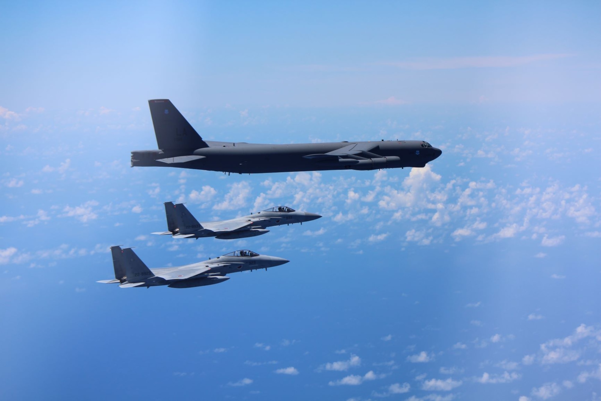 Two Japan Air Self-Defense Force (JASDF) F-15's escort a U.S. Air Force B-52 Stratofortress August 31, 2021 over the Indo-Pacific region. The JASDF and the U.S. Air Force conducted bilateral training to enhance deterrence and response capabilities. (Photo by Japan Air Self-Defense Force)