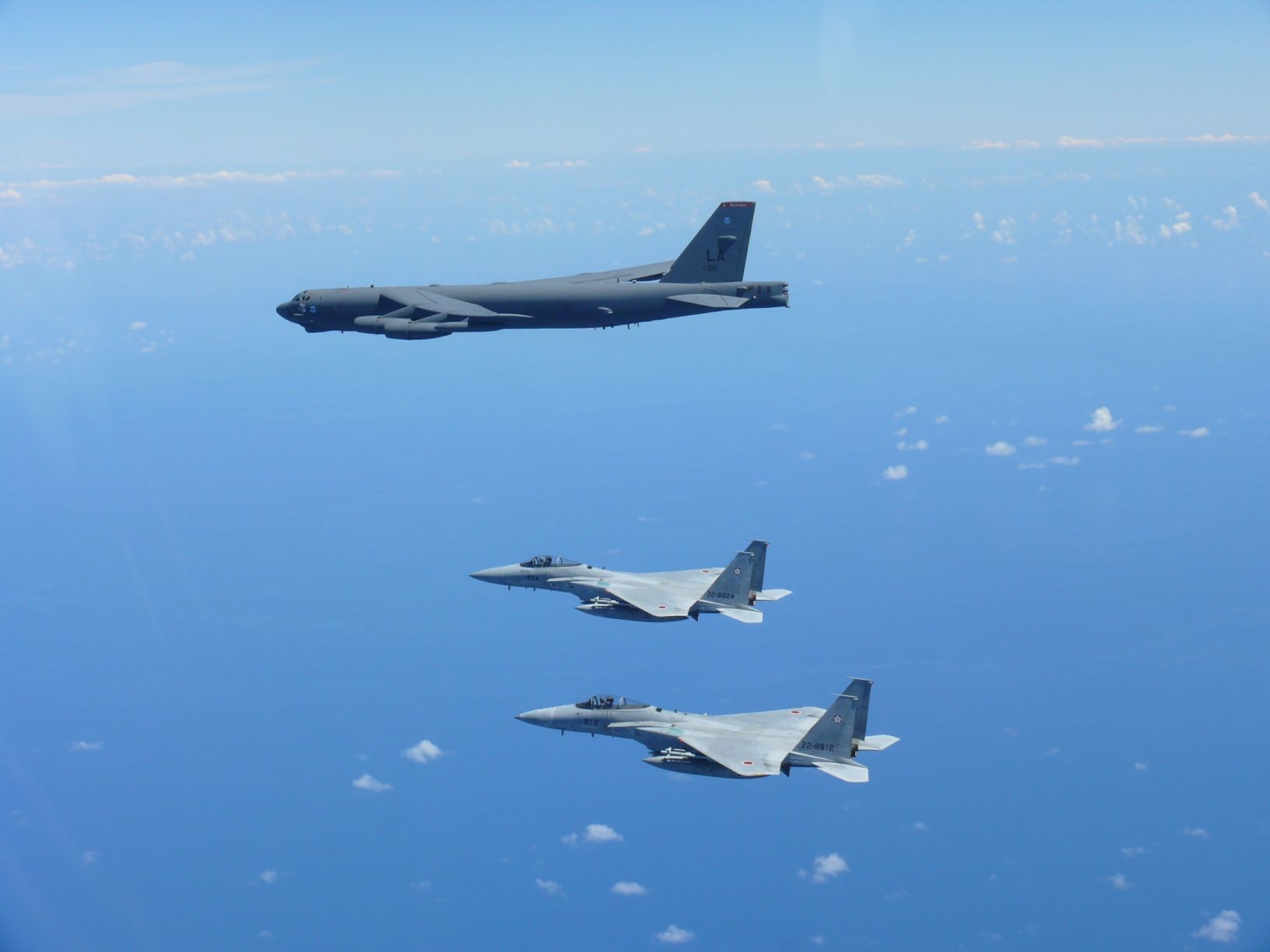 Two Japan Air Self-Defense Force (JASDF) F-15's escort a U.S. Air Force B-52 Stratofortress August 31, 2021 over the Indo-Pacific region. The JASDF and the U.S. Air Force conducted bilateral training to enhance deterrence and response capabilities. (Photo by Japan Air Self-Defense Force)