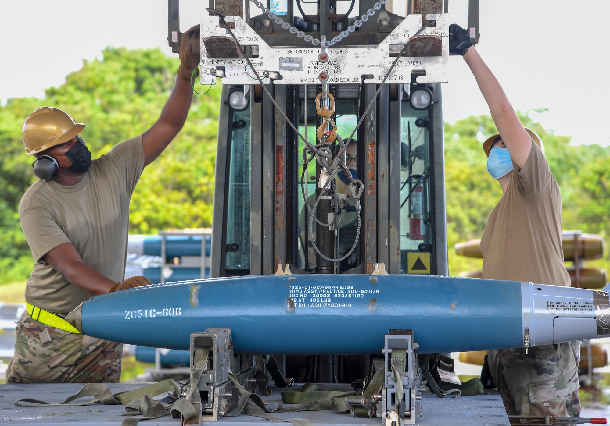 U.S. Air Force Airmen assigned to the 2nd Munitions Squadron, Barksdale Air Force Base, Louisiana, transport BDU-50 training bombs for Bomber Task Force missions, at Andersen Air Force Base, Guam, Aug. 27, 2021. Evaluating readiness and forward positioning bomber aircraft ensures the Department of Defense can maintain operational and support capabilities to meet security obligations. (U.S. Air Force photo by Senior Airman Taylor Hunter)