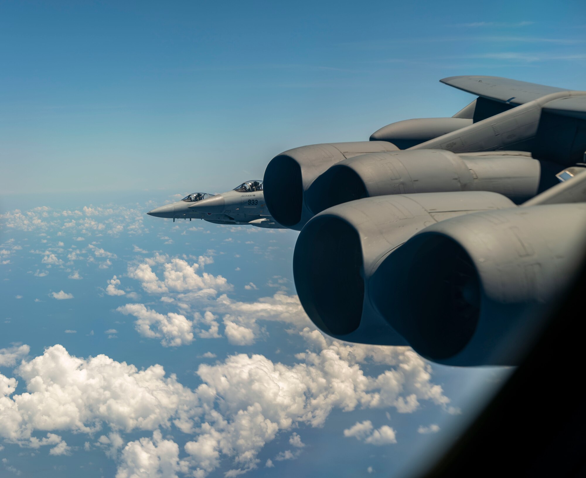 Two Japan Air Self-Defense Force (JASDF) F-15's escort a U.S. Air Force B-52 Stratofortress August 31, 2021 over the Indo-Pacific region. The JASDF and the U.S. Air Force conducted bilateral training to enhance deterrence and response capabilities. (U.S. Air Force photo by Senior Airman Charles T. Fultz)