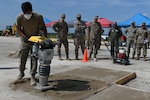 U.S. Air Force civil engineers from the pavements and construction equipment career field, from eight separate units, team up with U.S. Navy Seabees from the Naval Mobile Construction Battalion 133, Gulfport, Mississippi for an Expedient and Expeditionary Airfield Damage Repair (E-ADR) distinguished visitors’ demonstration at McEntire Joint National Guard Base, South Carolina, Aug. 31, 2021. The purpose of the training is to provide just enough, just in time repair capability with minimal cost and materials in a wartime situation.  (U.S. Air National Guard photo by Senior Master Sgt. Edward Snyder, 169th Fighter Wing Public Affairs)