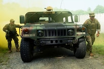 Master Sgt. Warren Jones, 107th Attack Wing religious affairs Airman, and Capt. Jeff Bartz, 107th AW chaplain, exit a Humvee during the Deployed Security Operations Chaplains Course, Aug. 26, 2021, at the Camp Ethan Allen Training Site, Jericho, Vermont. The three-day course was developed by 158th religious affairs and security forces Airmen as a crash course in weapons handling and familiarization, general security procedures, convoy operations and improvised explosive device recognition.