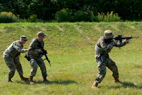 Staff Sgt. Taylor Specht, 158th Fighter Wing chapel readiness NCOIC, and Tech. Sgt. Ryan Brier, 158th FW chapel operations NCOIC, provide simulated cover for Capt. Wilson Treftz, 158th FW chaplain, during the Deployed Security Operations Chaplains Course.