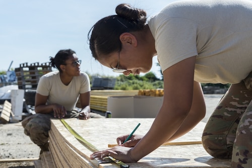 Two female Airmen work on engineering projects. A Women's Initiatives Team is one of eight Barrier Analysis Working Groups under the Air Force Materiel Command Major Command Barrier Analysis Working Group umbrella, which was created as part of ongoing efforts to drive greater diversity and inclusion across the enterprise.