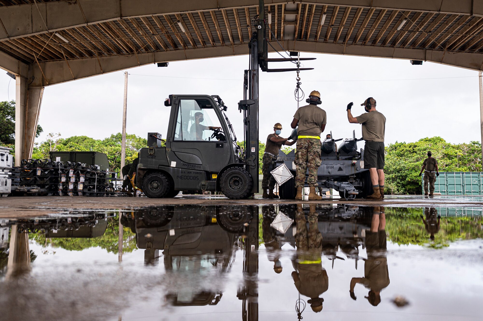 U.S. Air Force Airmen assigned to the 2nd Munitions Squadron and 707th Maintenance Squadron, Barksdale Air Force Base, Louisiana, transport BDU-50 training bombs for Bomber Task Force missions, at Andersen Air Force Base, Guam, Aug. 27, 2021. Andersen acts as a staging point for the B-52, allowing commanders to address a variety of global challenges through the engagement of the bomber. (U.S. Air Force photo by Staff Sgt. Devin M. Rumbaugh)