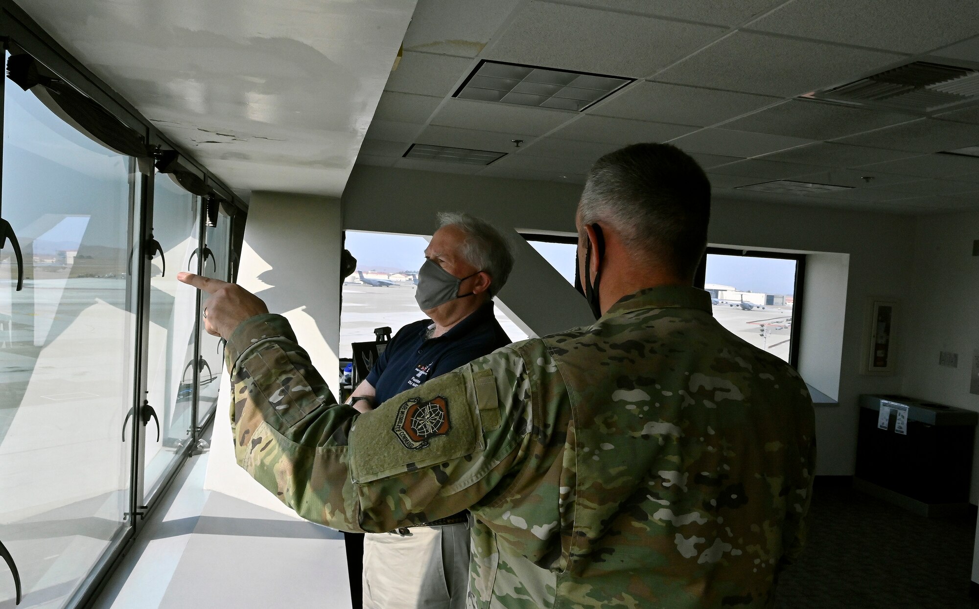 Secretary of the Air Force Frank Kendall is briefed by Col. Corey Simmons, 60th Air Mobility commander on flightline operations from the tower at Travis Air Force Base, Calif., Aug. 16, 2021. Kendall made a stop at Travis AFB and was greeted by wing leadership. (U.S. Air Force photo by Wayne Clark)