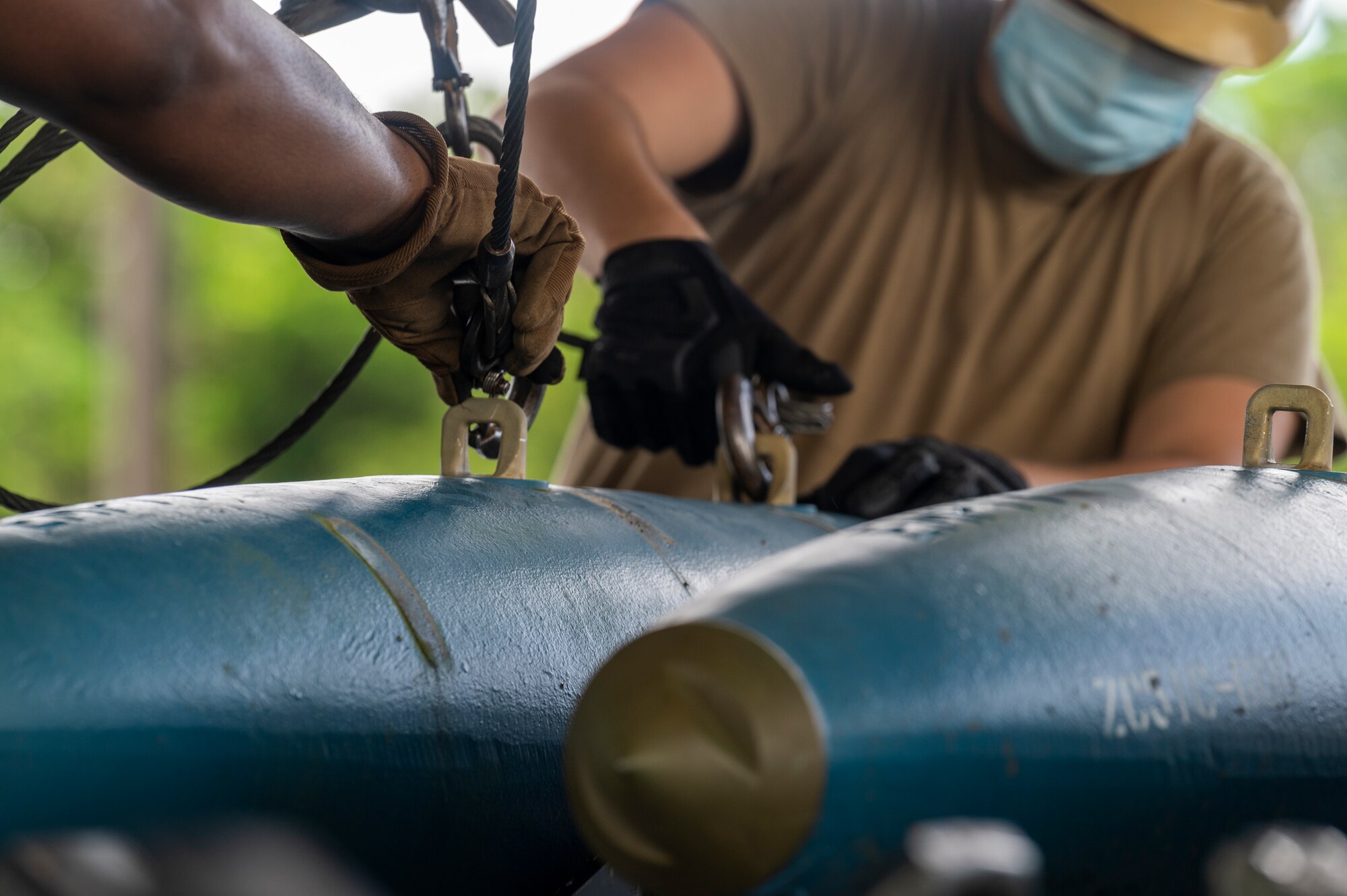 U.S. Air Force Airmen assigned to the 2nd Munitions Squadron and 707th Maintenance Squadron, Barksdale Air Force Base, Louisiana, prepare to transport BDU-50 training bombs for Bomber Task Force (BTF) missions at Andersen Air Force Base, Guam, Aug. 27, 2021. In line with the National Defense Strategy’s objectives of strategic predictability and operational unpredictability, the BTF enables a mix of different types of bombers to operate forward in the Indo-Pacific region from a broad array of overseas and Continental U.S. locations with greater operational resilience. (U.S. Air Force photo by Staff Sgt. Alysia T. Blake)