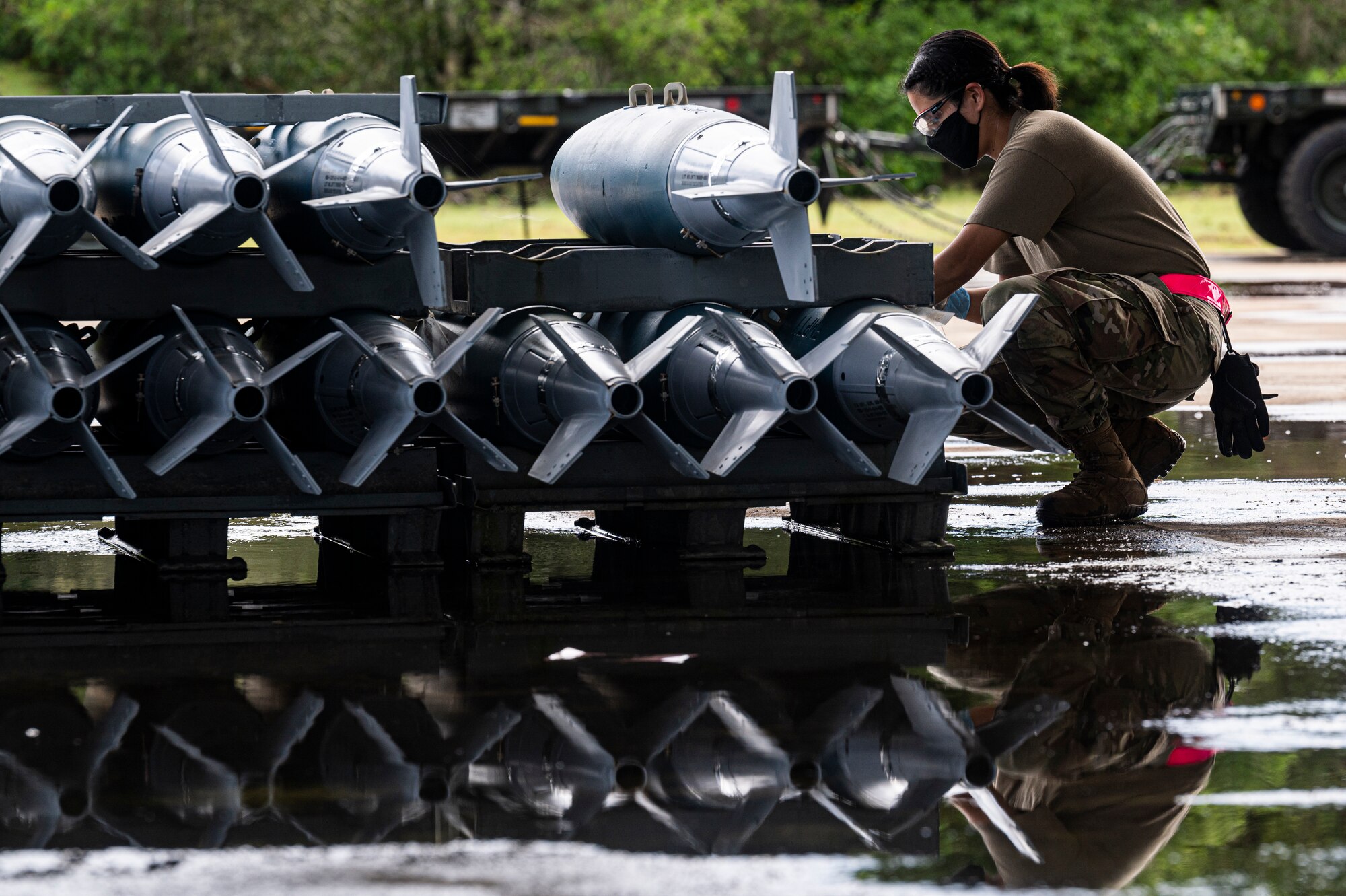 U.S. Air Force Staff Sgt. Amanda Solis, conventional maintenance inspector, assigned to the 2nd Munitions Squadron, Barksdale Air Force Base, Louisiana, spray paints identifying marks on the side of a BDU-50 training bomb for Bomber Task Force missions at Andersen Air Force Base, Guam, Aug. 27, 2021. U.S. Strategic Command bomber task forces regularly conduct combined theater security cooperation engagements with allies and partners, demonstrating the U.S. capability to command, control and conduct bomber missions across the globe. (U.S. Air Force photo by Staff Sgt. Devin M. Rumbaugh)