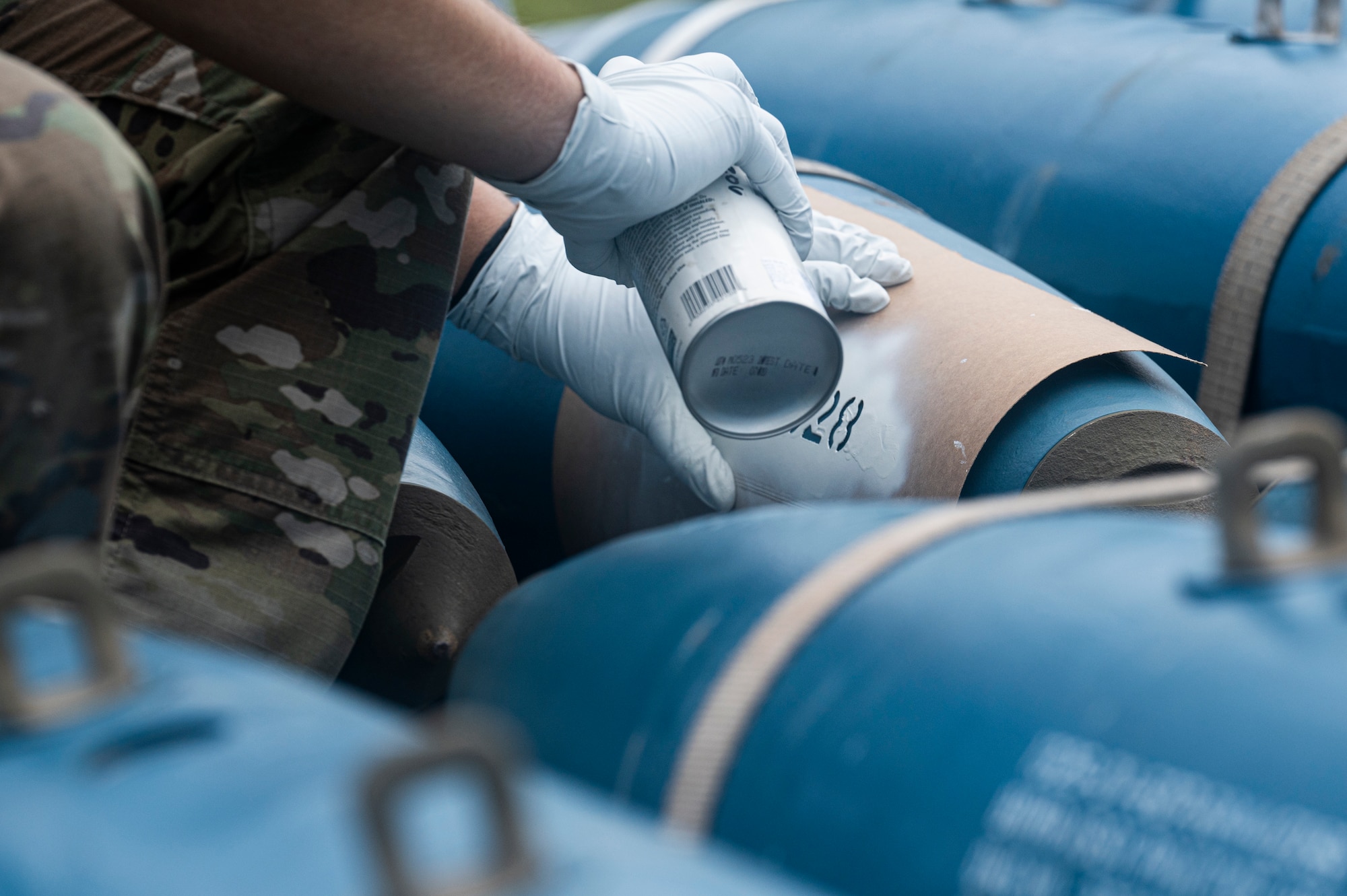 U.S. Air Force Airman 1st Class Jordan Dworaczyk, trailer maintenance crew member, assigned to the 2nd Munitions Squadron, Barksdale Air Force Base, Louisiana, spray paints identifying marks on the side of a BDU-50 training bomb for Bomber Task Force (BTF) exercise at Andersen Air Force Base, Guam, August 27, 2021. In line with the National Defense Strategy’s objectives of strategic predictability and operational unpredictability, the BTF enables a mix of different types of bombers to operate forward in the Indo-Pacific region from a broad array of overseas and continental U.S. locations with greater operational resilience. (U.S. Air Force photo by Staff Sgt. Devin M. Rumbaugh)