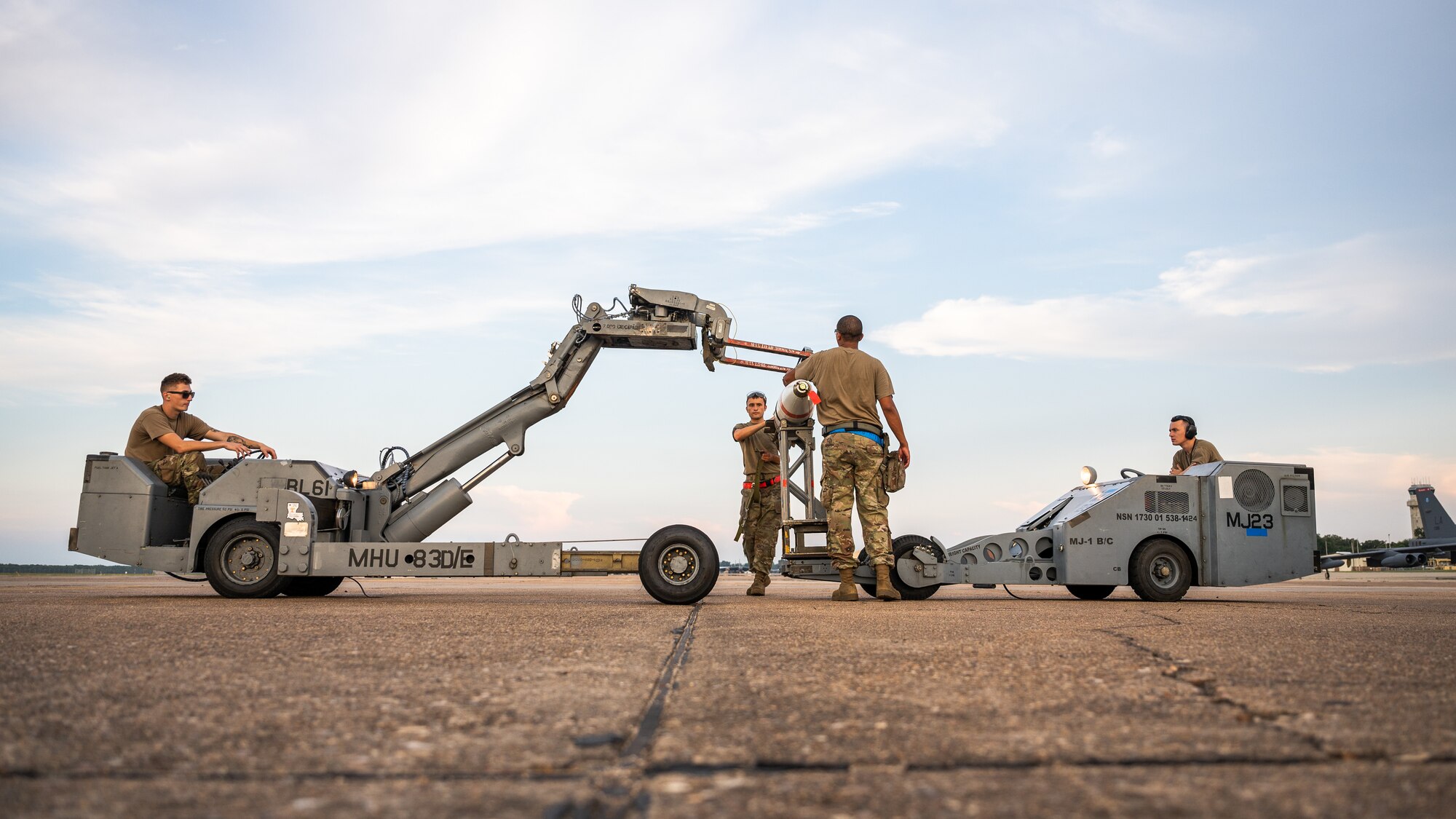 A weapons load crew team from the 2nd Aircraft Maintenance Squadron transfer a MK-62 Quickstrike naval mine in support of a Bomber Task Force deployment at Barksdale Air Force Base, Louisiana, Aug. 25, 2021. The 2nd AMXS is proficiently trained in the loading of naval mines, as well as conventional and nuclear weapons. (U.S. Air Force photo by Senior Airman Jacob B. Wrightsman)