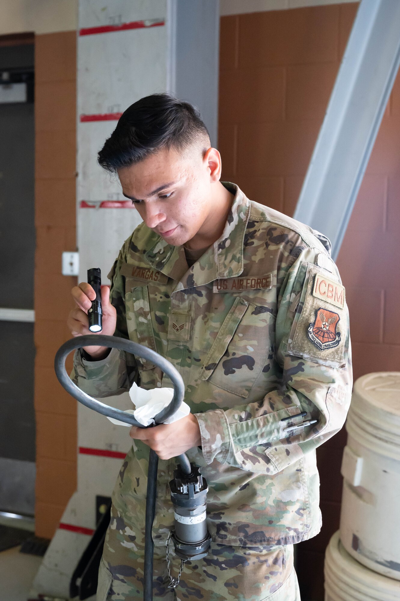 Senior Airman Joseph Vargas, 741st Maintenance Squadron mechanical and pneudraulics technician, inspects a component of a hydraulic actuator power unit July 28, 2021, at Malmstrom Air Force Base, Mont.